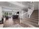 Open-concept living room with soaring ceilings, cozy furniture, fireplace, and staircase at 8700 Ehler Pkwy, Brighton, CO 80602