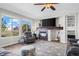 Inviting living room with a fireplace, large windows, hardwood floors, and comfortable seating at 8700 Ehler Pkwy, Brighton, CO 80602