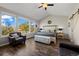 Inviting main bedroom with large windows, vaulted ceiling, cozy seating area, and ample natural light at 8700 Ehler Pkwy, Brighton, CO 80602