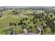 Expansive aerial view shows a home surrounded by lush greenery, trees, and vast open spaces at 12189 N Boot Hill Dr, Parker, CO 80138