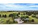 Aerial view of home featuring a large lot, mature trees, long driveway and an RV parked near the house at 12189 N Boot Hill Dr, Parker, CO 80138