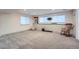 Basement area featuring plush carpets, three windows, a comfortable rocking chair and modern decor at 12189 N Boot Hill Dr, Parker, CO 80138