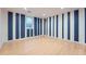 Bright basement area features unique blue and white striped accent walls and vinyl flooring at 12189 N Boot Hill Dr, Parker, CO 80138