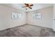 Bright bedroom features plush gray carpeting, ceiling fan and two windows with views to the exterior at 12189 N Boot Hill Dr, Parker, CO 80138