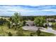 Aerial view of home featuring a large lot, mature trees, long driveway and an RV parked near the house at 12189 N Boot Hill Dr, Parker, CO 80138
