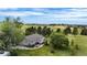 Aerial view of home with a large deck, expansive green space and mature trees surrounding the property at 12189 N Boot Hill Dr, Parker, CO 80138