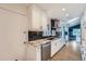 Modern kitchen with granite countertop, stainless steel appliances, and contrasting black tile backsplash at 12189 N Boot Hill Dr, Parker, CO 80138