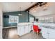 Open floor plan featuring a kitchen and a living room with wood-look floors and a cozy breakfast bar at 12189 N Boot Hill Dr, Parker, CO 80138