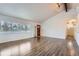Inviting living room with wood-look floors, large window and bright natural light at 12189 N Boot Hill Dr, Parker, CO 80138