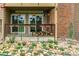 Charming patio with a brick wall, decorative rocks, and flower garden. Includes a wood pile for the fireplace at 4899 S Dudley St # 3, Littleton, CO 80123