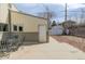 Backyard with metal patio set and outdoor access to garage, with rock ground cover at 396 Tucson St, Aurora, CO 80011
