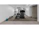 Finished basement with home gym featuring carpet flooring and access to a utility door at 396 Tucson St, Aurora, CO 80011
