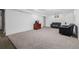 Finished basement showcasing neutral paint, new carpet, and abundant room for a living space at 396 Tucson St, Aurora, CO 80011