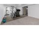 Finished basement with home gym featuring carpet flooring and access to a utility door at 396 Tucson St, Aurora, CO 80011