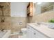 Bathroom featuring a tiled shower, vanity with storage, and modern fixtures at 396 Tucson St, Aurora, CO 80011
