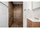 Compact bathroom featuring tiled shower, vanity, and towel rack at 396 Tucson St, Aurora, CO 80011