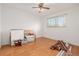 Empty bedroom showing hardwood floors, a ceiling fan, and a window for natural light at 396 Tucson St, Aurora, CO 80011