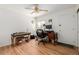 Versatile room includes hardwood floors, a ceiling fan and room for a piano, desk, and computer at 396 Tucson St, Aurora, CO 80011