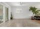 Sunroom featuring tile flooring, a large window, and a sliding glass door at 396 Tucson St, Aurora, CO 80011