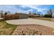A long concrete driveway leads to the home's garage, complemented by decorative rocks and landscaping at 396 Tucson St, Aurora, CO 80011