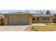Charming brick home featuring a two-car garage, well-maintained lawn, and a welcoming front entrance at 396 Tucson St, Aurora, CO 80011