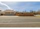 Backyard view featuring home and adjacent three car garage at 396 Tucson St, Aurora, CO 80011