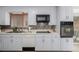 Kitchen featuring modern appliances, a stainless steel sink, and white cabinets at 396 Tucson St, Aurora, CO 80011