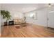 Bright living room featuring hardwood floors, large windows, and a comfortable seating area at 396 Tucson St, Aurora, CO 80011