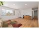 Bright living room with large windows, hardwood floors, and a neutral color scheme at 396 Tucson St, Aurora, CO 80011
