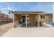 Enclosed patio featuring concrete flooring, mature landscaping, and access to the backyard at 396 Tucson St, Aurora, CO 80011