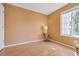 Cozy bedroom featuring a window for natural light and wood-look laminate flooring at 13782 E Lehigh Ave # H, Aurora, CO 80014
