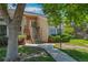 Townhome exterior featuring well-kept landscaping, sidewalk, and staircase leading to the entrance at 13782 E Lehigh Ave # H, Aurora, CO 80014