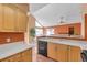Bright kitchen features wood cabinets, sleek countertops, and an open layout to the living area at 13782 E Lehigh Ave # H, Aurora, CO 80014