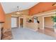 Open-concept living room with fireplace, ceiling fan and view to the kitchen at 13782 E Lehigh Ave # H, Aurora, CO 80014