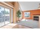 Bright living room showcasing a sliding glass door, big windows, and a fireplace at 13782 E Lehigh Ave # H, Aurora, CO 80014