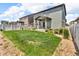 A well-maintained backyard with a lush lawn, partial fencing, and tasteful landscaping at 6591 N Ceylon St, Denver, CO 80249