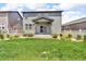 Backyard featuring a lawn, patio, and partial fencing, perfect for outdoor activities at 6591 N Ceylon St, Denver, CO 80249