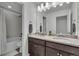 This bathroom features a double sink with a granite countertop, as well as a bathtub and shower at 6591 N Ceylon St, Denver, CO 80249