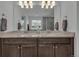 Bright bathroom featuring double sinks, granite countertops and decorative fixtures at 6591 N Ceylon St, Denver, CO 80249