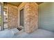 Close-up of a stone entryway and front door with a 'Hello Goodbye' welcome mat on the front porch at 6591 N Ceylon St, Denver, CO 80249