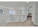 Upstairs hallway that opens to a bedroom with carpet flooring and natural light at 6591 N Ceylon St, Denver, CO 80249