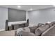 Home theater featuring a large screen, surround sound speakers, and a comfortable gray couch at 6591 N Ceylon St, Denver, CO 80249