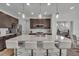 Modern kitchen island with barstool seating, stainless steel appliances and a view into an adjacent office space at 6591 N Ceylon St, Denver, CO 80249
