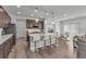 Modern kitchen with an island, barstool seating, stainless steel appliances and an open dining area at 6591 N Ceylon St, Denver, CO 80249
