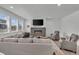 Comfortable living room featuring a gray tile fireplace and lots of bright, natural light at 6591 N Ceylon St, Denver, CO 80249