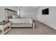 Bright main bedroom with white walls, carpeted floor, and a stylish wooden bed frame at 6591 N Ceylon St, Denver, CO 80249