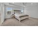 Spacious primary bedroom with carpet floors, tray ceiling, and comfortable furniture at 6591 N Ceylon St, Denver, CO 80249
