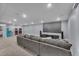 Spacious recreational room with a large projector screen, comfortable couch, and multiple arcade machines at 6591 N Ceylon St, Denver, CO 80249
