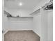 A simple and well-organized walk-in closet providing ample storage space at 6591 N Ceylon St, Denver, CO 80249