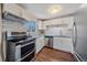 Modern kitchen with stainless steel appliances and white cabinetry at 3734 Miller Ct, Wheat Ridge, CO 80033
